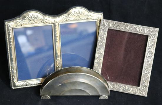 A German 800 standard silver letter rack and two sterling silver photograph frames.